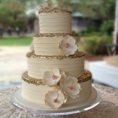 Couture-wedding-cake-magnolia-fondant-flowers-gold-trim